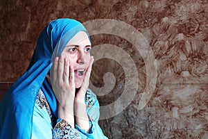 Happy surprised arab muslim woman