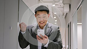 Happy surprised Asian mature man emotional winner male chinese korean businessman smiling entrepreneur winning business
