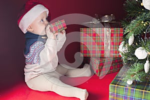 Happy surprised baby holding gift box, present, Christmas, eve