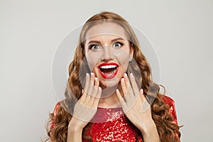 Happy surprised exsited woman with long wavy hair red lips makeup and french manicured nails  on white background