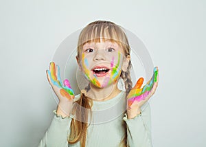 Happy surprised little girl with colorful painted hands drawing. Pretty child art school student on white background