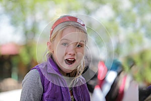 Happy surprised little girl, outdoor portrait