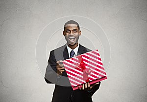 Happy, surprised man receiving gift from someone