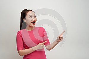 Happy surprised young female smiling broadly at camera, pointing fingers away photo