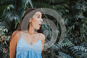 Happy and surprised young woman traveler at beach vacation