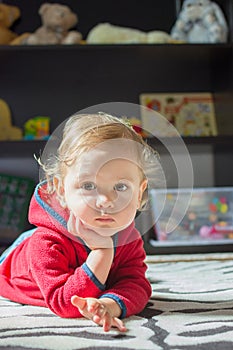 Happy sweet little baby boy portrait with toys in the background