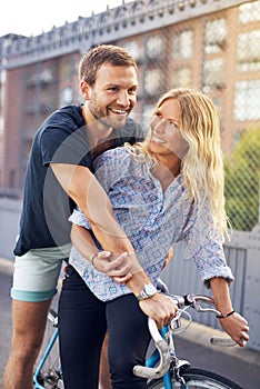 Happy Sweethearts Riding Bicycle at the Street