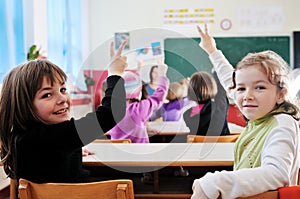 Happy teacher in school classroom