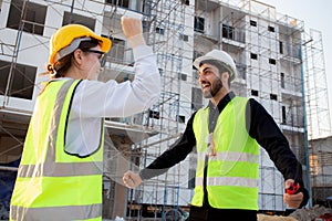 Happy team of architect or engineer with success and glad at construction site, team contractor or worker or partner glad with