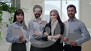 Happy team group business people diverse office coworkers looking at camera smiling posing together crossed hands for
