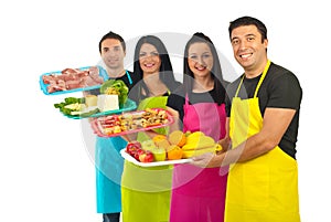 Happy team of market workers with fresh food photo