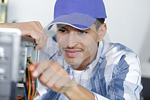 happy technician repairing computer