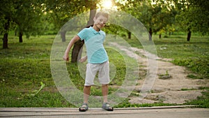 Happy teen boy dancing outside. Smiling guy making rhythmical movements outdoors