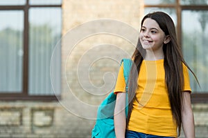 Happy teen carry backpack. smiling kid in schoolyard. childhood happiness. girl ready for lesson. get best education