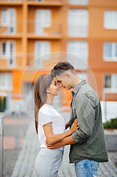 Happy teen couple embracing at street.