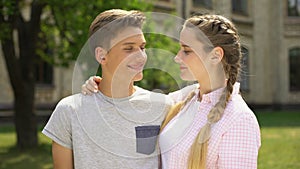 Happy teen couple kissing and looking at each other, pure relations, tenderness