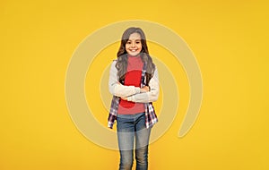 happy teen girl in casual clothes on yellow background, teeny