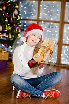 Happy teen girl with christmas gift box