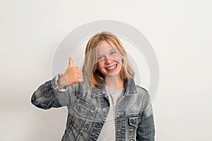 Happy teen girl with dental brace showing thumb up gesture