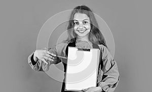 happy teen girl with document folder. happy childhood. pretty child on studio background.