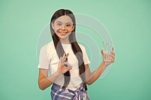 happy teen girl drink glass of water to keep daily water balance show ok gesture, drink water.