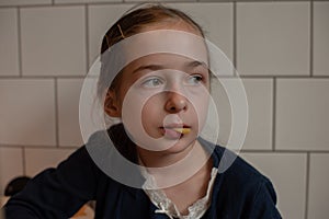 Happy teen girl eating a burger and french fries. Schoolgirl eating a burgerand french fries