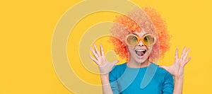 happy teen girl in fancy clown wig wear funny party glasses, surprise. Funny teenager child in wig, party poster. Banner