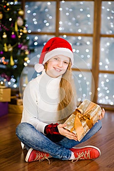 Happy teen girl with gift box in their hands
