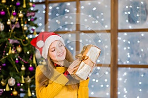 Happy teen girl with gift box in their hands