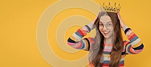 happy teen girl in glasses wear princess crown on yellow background, prom. Child queen princess in crown horizontal