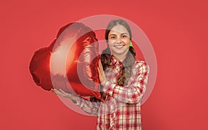 happy teen girl hold love heart balloon on red background