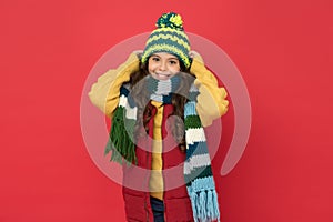 Happy teen girl in knitted scarf and hat wear warm clothes in winter season, cozy fashion