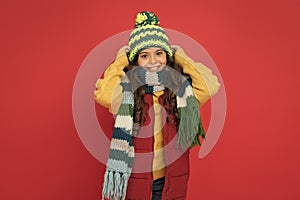 happy teen girl in knitted scarf and hat wear warm clothes in winter season, cozy fashion