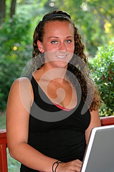 Happy Teen Girl With Laptop Outdoors