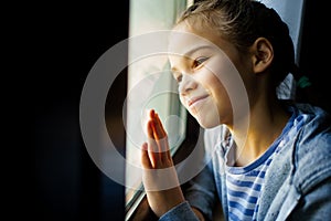 Happy teen girl look out of window outside. recovered.