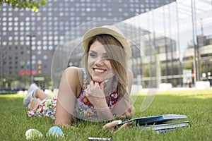 Happy Teen Girl Lying on her Stomach on the Grass