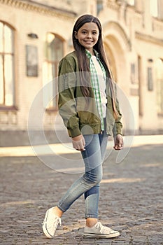 Happy teen girl model posing in casual trendy style outdoors, fashion