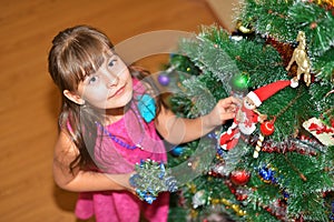 Happy teen girl near decorated Christmas tree