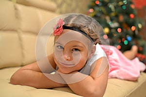 Happy teen girl near decorated Christmas tree