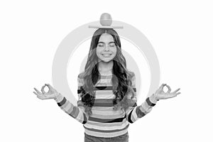 happy teen girl with orange fruit and school copybook meditating isolated on white, meditation.