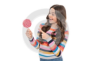 happy teen girl pointing finger on lollipop isolated on white background, caramel shop.