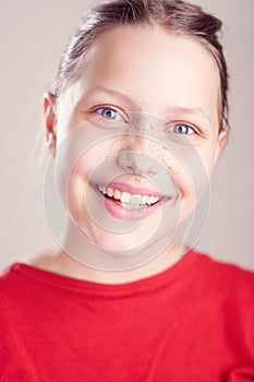 Happy teen girl with scrub mask on her face