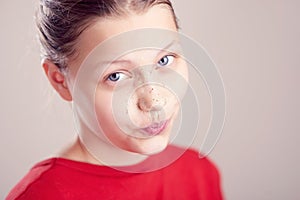 Happy teen girl with scrub mask on her face