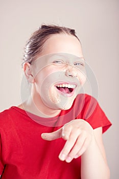 Happy teen girl with scrub mask on her face