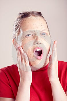 Happy teen girl with scrub mask on her face