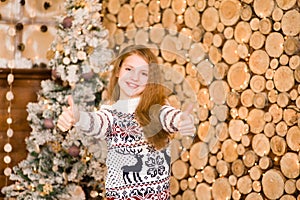 Happy teen girl showing thumbs up