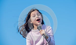happy teen girl singing karaoke in mic