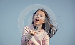 happy teen girl singing karaoke in mic