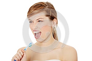 Happy teen girl singing to tooth brush