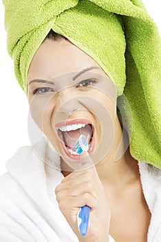 Happy teen girl singing to tooth brush